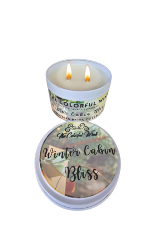 Winter Cabin Bliss Medium Candle in a white tin with a green and gold label.